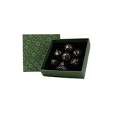 Set of dice with gold and black details in a green box with geometric pattern
