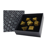 Set of gold dice with intricate patterns in a black box with geometric pattern