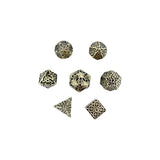 Set of metallic dice with intricate designs on a white background