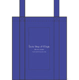 Blue tote bag with 'Little Shop of Magic' branding on a white background