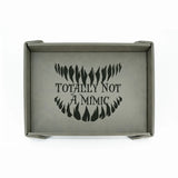 Gray tray with 'Totally Not A Mimic' text and design on a white background