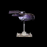 Model spaceship on a stand against a black background