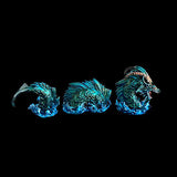 Three dragon head sculptures in a row on a black background