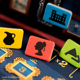 Close-up of game pieces with symbols on a board game surface