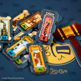 Close-up of colorful game cards with various illustrations on a dark background
