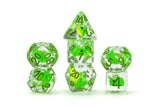 Set of green and clear dice on a white background