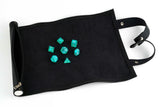 Black dice bag with turquoise dice on a white background