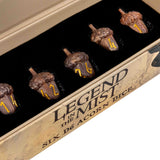 A close-up of a boxed set containing six acorn-shaped dice nestled in a black tray. The box is tan with printed text reading 'LEGEND IN THE MIST' and 'SIX D6 ACORN DICE.