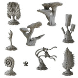 Collection of various gray stone sculptures on a white background