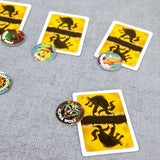 Card game with wolf-themed cards and tokens on a gray surface