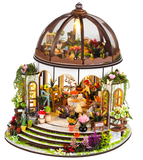 Detailed model of a miniature garden with a dome, plants, and furniture on a white background