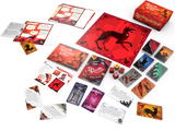Board game components including cards and a box with a red cover featuring a black dog illustration on a white background.