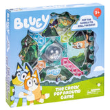 Bluey game box with dice and characters on a blue and green background