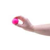 Needoh fuzz ball being held in a hand on a white background 