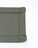 Gray leather-bound notebook on a white background
