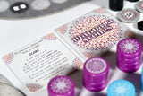 Board game components including dice and score cards on a table.