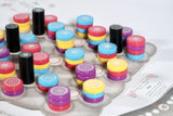 Colorful cylindrical objects on a textured surface with a blurred background