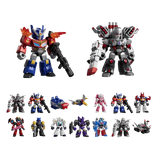 A set of small Transformers-style toy robots and vehicles arranged on a plain white background, including Optimus Prime, a large silver-and-red robot, several smaller robot figures, and toy cars/planes.