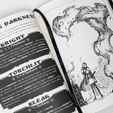 Open book with game rules and black and white illustrations on a white background
