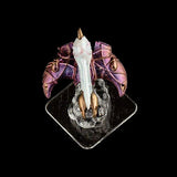 Small figurine of a dragon with purple wings on a clear stand against a black background