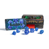 Blue dice set with 'Baubles' packaging and a monster-themed box in the background.
