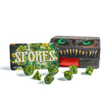 Spores dice game set with green dice and packaging on a white background