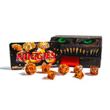Set of orange dice with 'Nuggies' branding in front of a box with a dragon design.