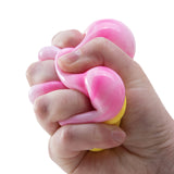 Hand holding a pink and yellow needoh ice cream cone against a white background