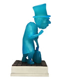 Blue statue of a figure with a top hat on a white background