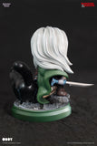 Miniature figurine of Drizzt with white hair and green hood on a dark background