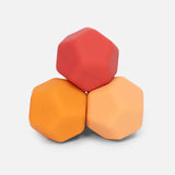Three hexagonal blocks in red, orange, and yellow on a light gray background
