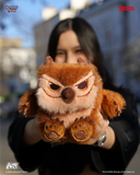 Person holding a fluffy brown and white creature plush toy outdoors.
