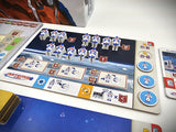Board game with space-themed elements and character figures on a table.