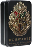 A black rectangular metal tin featuring the Hogwarts crest and the text 'HOGWARTS SCHOOL OF WITCHCRAFT AND WIZARDRY' on the front.