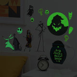 Glow-in-the-dark Halloween wall decals and a matching night light displayed on a wall in a dark room. The set includes Jack Skellington, Sally, a ghoulish moon, skulls, a ghost, a haunted house, and a jar-shaped night light that reads 'Deadly Night Shade'.