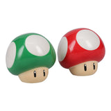 Two mushroom-shaped figurines, one green and one red, on a white background