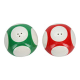 Two mushroom-shaped salt and pepper shakers, one green and one red, on a white background.