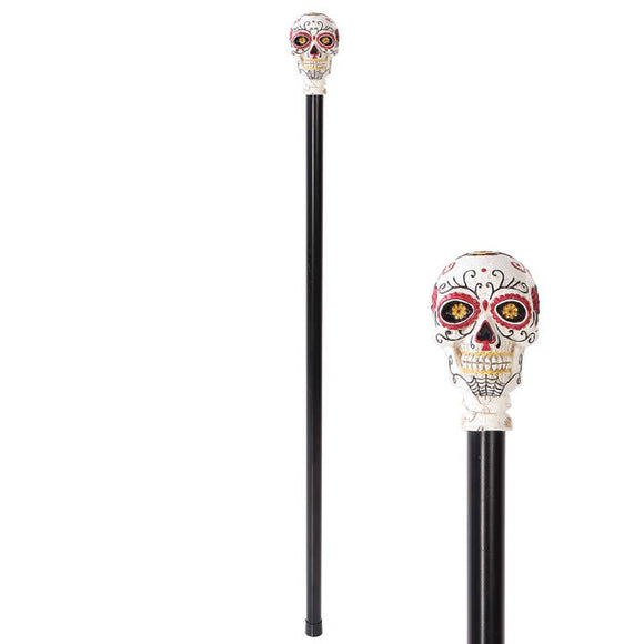 Decorative walking cane with skull design on a white background