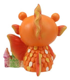 Orange dragon-like figurine with a small castle on a white background