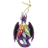 A purple dragon Christmas ornament with gold wings and a gold hanging string, featuring red and green ornaments on its back, set against a plain white background.