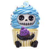 Cupcake-shaped toy with a skeleton face and purple frosting on a white background