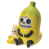 Toy figure of a skeleton in a banana costume with a smaller smiling banana figure inside, on a white background.