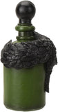 An ornate green glass bottle with a dark, textured feather-like wrap around the neck and a round black stopper, shown against a plain white background.
