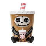 Squishy toy resembling a skeleton in a coffee cup with a straw on a white background