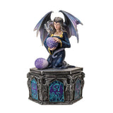 Decorative figurine of a woman with dragon wings holding a purple orb on a white background