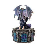 Decorative figurine of a dragon on a pedestal with a white background