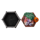 Hexagonal black box with a decorative lid featuring a witch and pumpkin on a white background