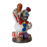 Colorful clown figurine with a white face and red, blue, and purple accents on a white background