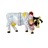 A decorative figurine of a cow wearing a white harness with rhinestones, yellow patches, a red and white floral crown, and black sunglasses, isolated on a white background.