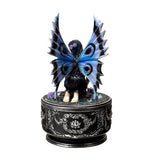 Decorative figurine of a dog with butterfly wings on an ornate base